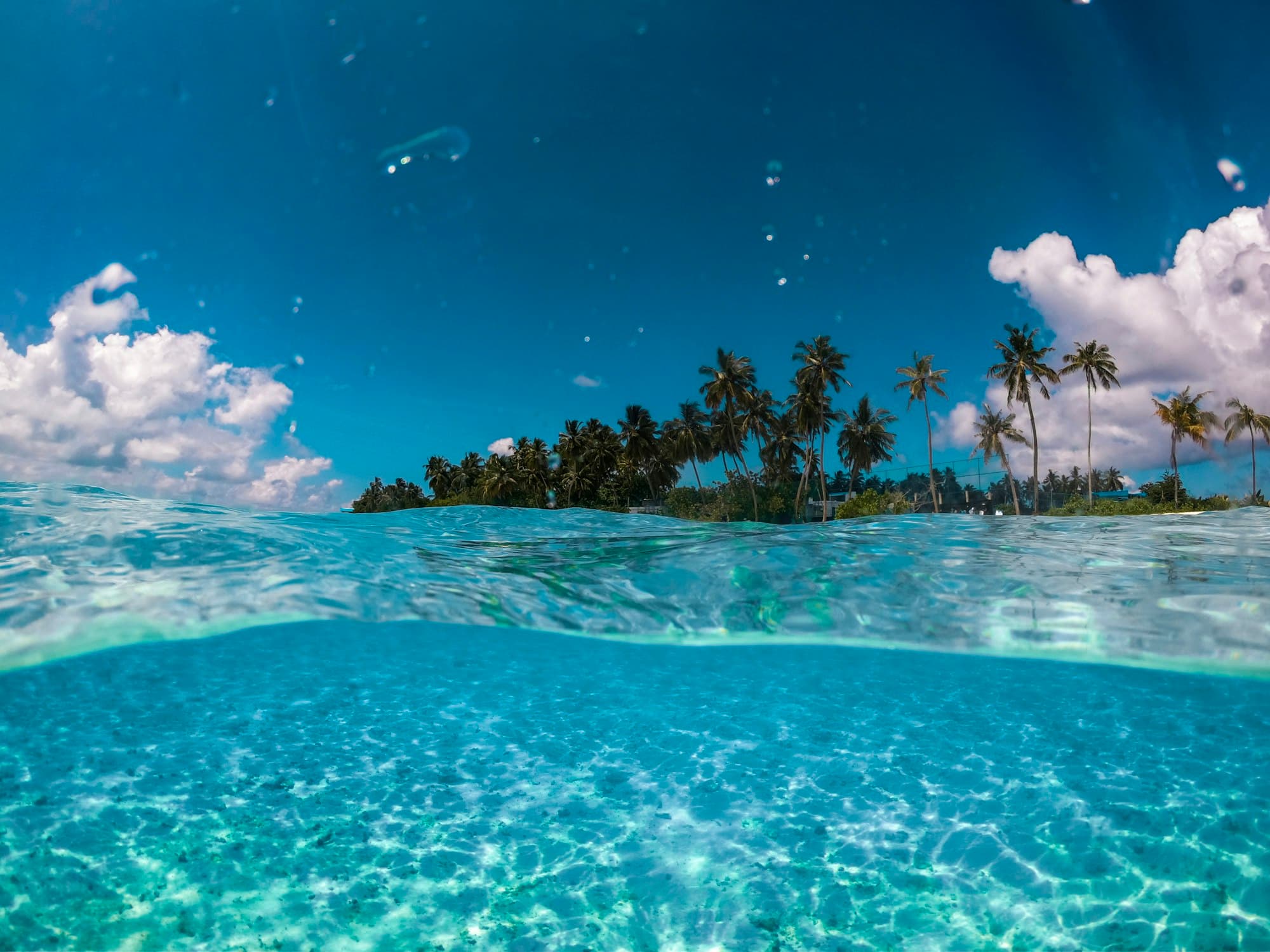 Clear turquoise water beside a tropical island