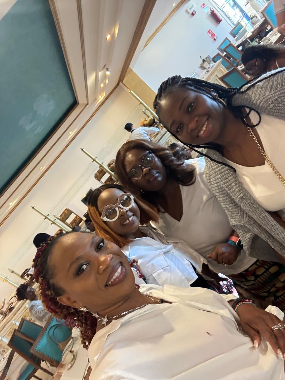 Four women taking a selfie at breakfast