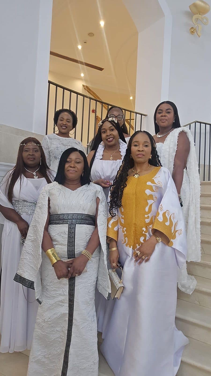 SHE-CATION 3.0 guests in white and gold on a marble staircase